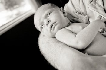 Baby looks out the windows from Dad's arms