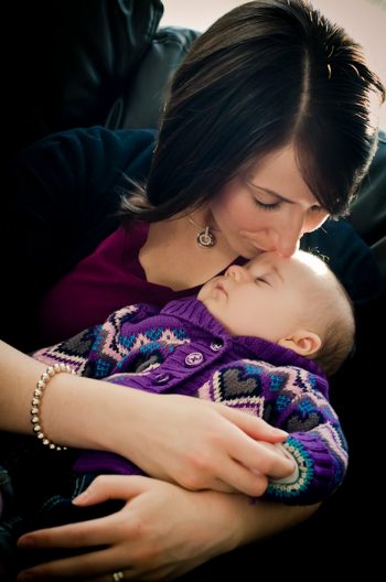 Mother kisses her baby