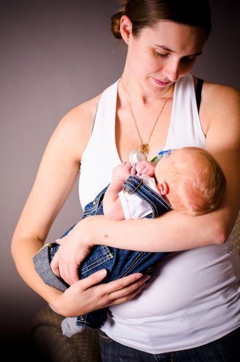 Woman looking at her baby, in the style of Madonna and Child painting