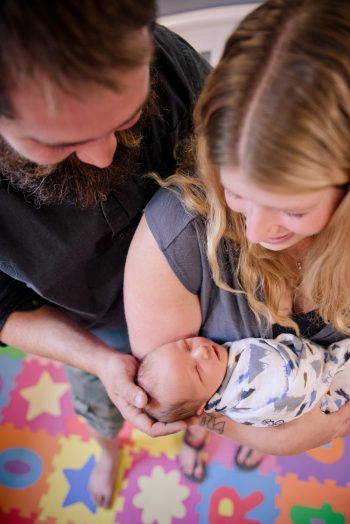 Unique photo of a couple with their newborn